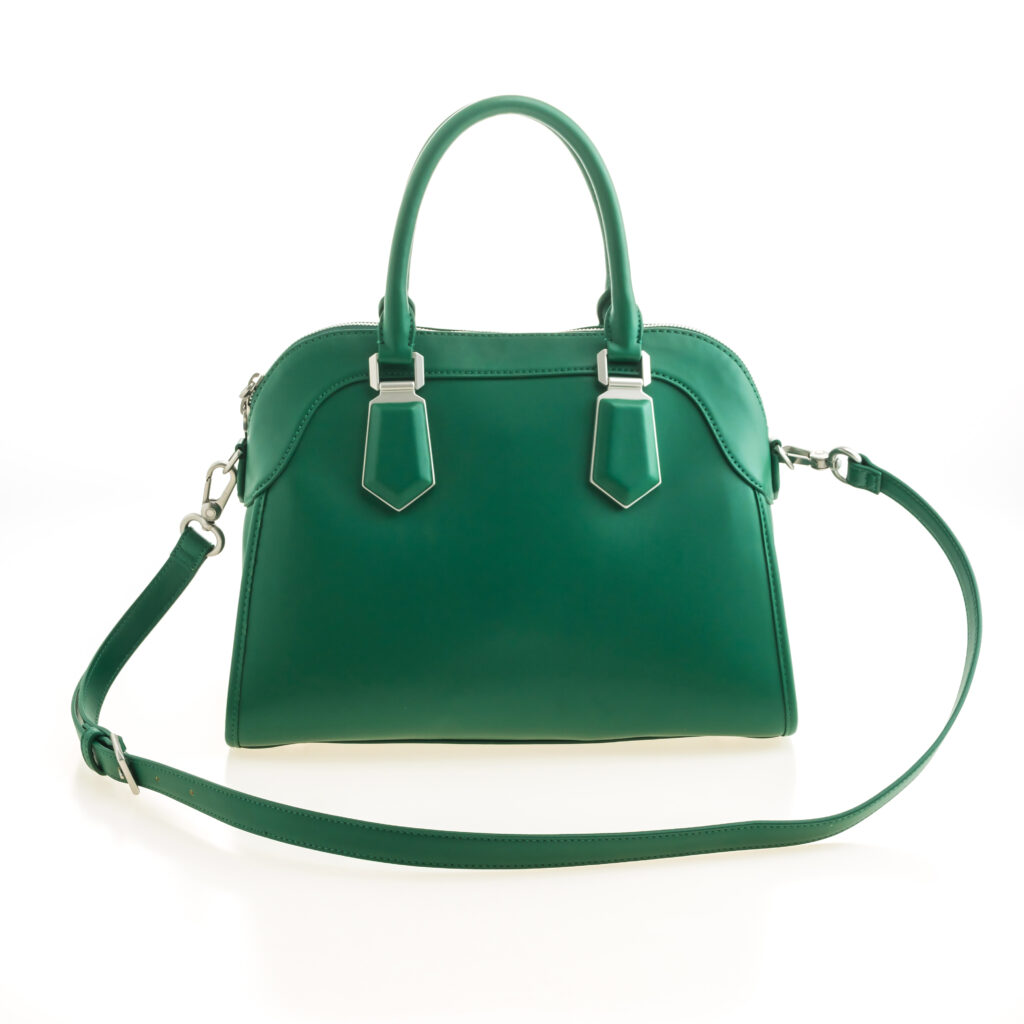 Beautiful elegance and luxury fashion leather green women handbag isolated on white background